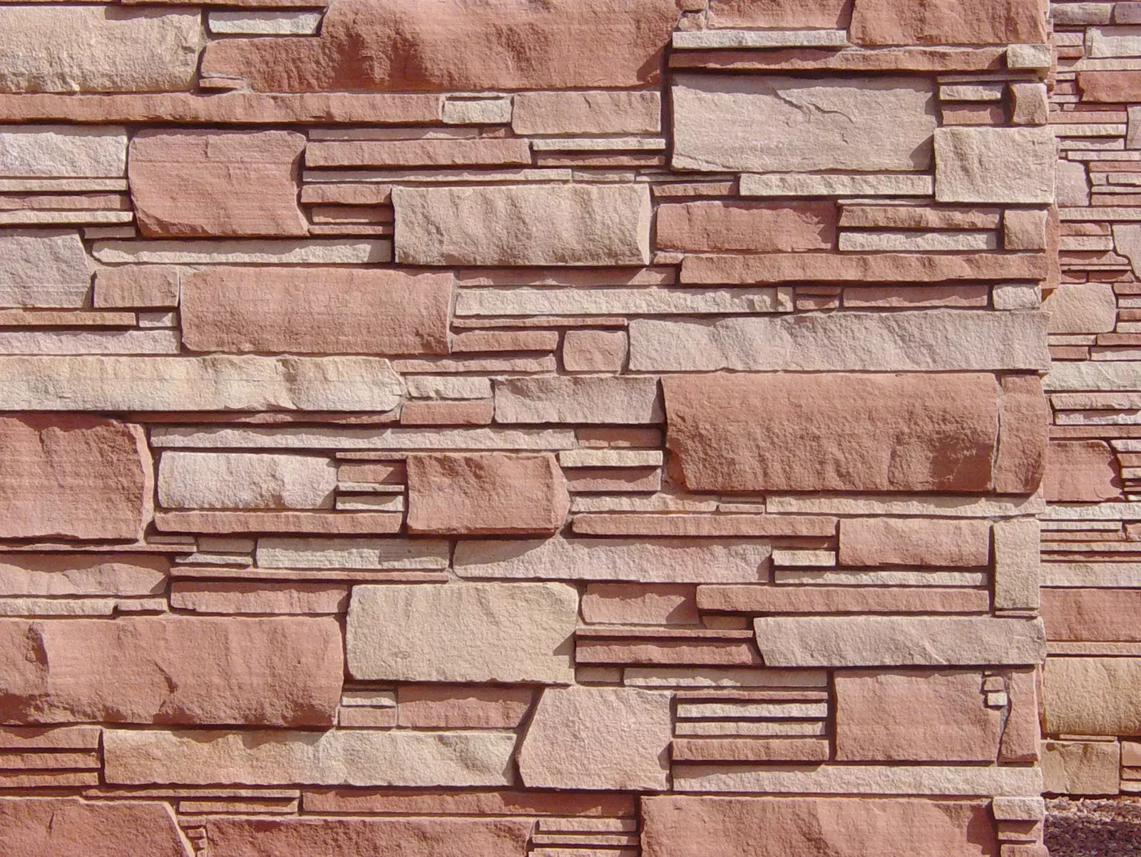 Layered stone veneer in warm red and cream tones
