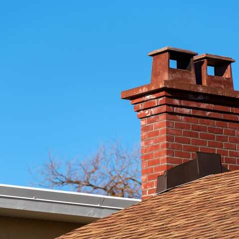 Close view of a brick chimney showing weathered masonry